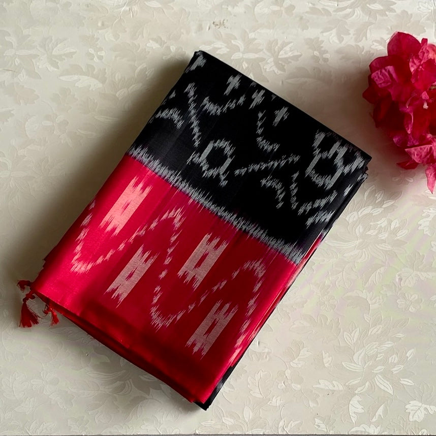 Stunner Jet Black Designer Ikkat Woven Pure silk with Tomato Pink Borders & Pallu