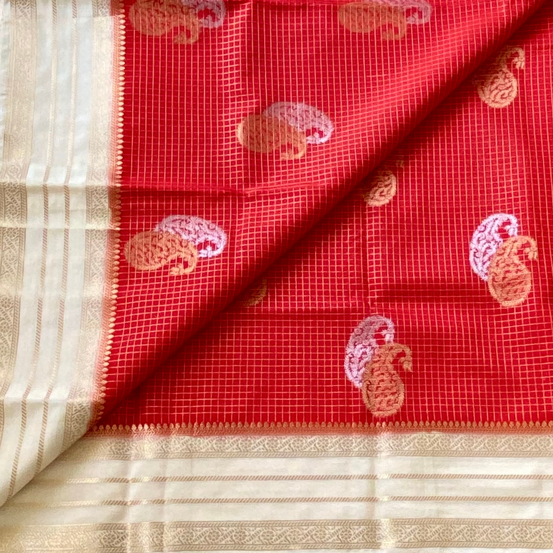 Orangish Red with pearl white soft crepe with double paisley buttas