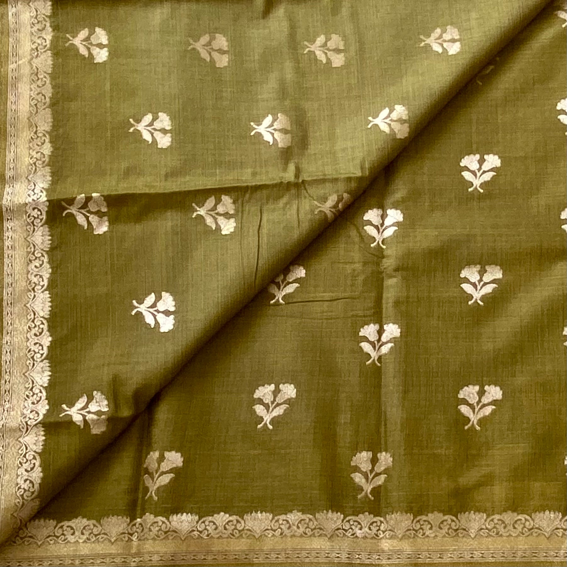 Olive Green soft tussar with antique silver buttas and lotus borders