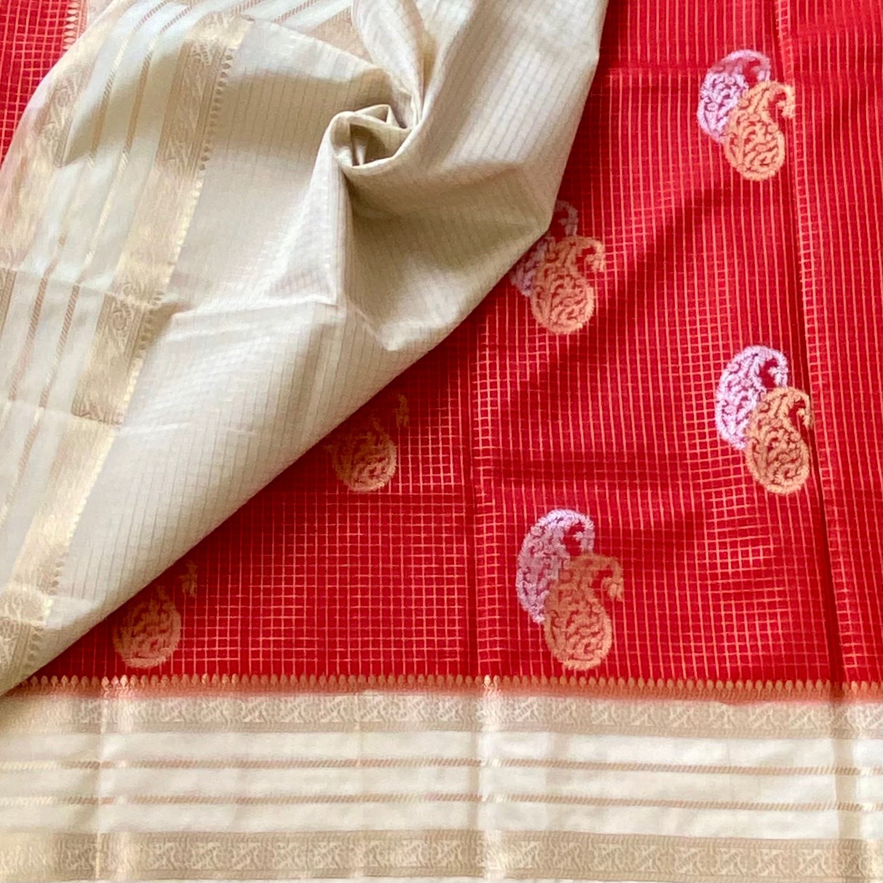 Orangish Red with pearl white soft crepe with double paisley buttas