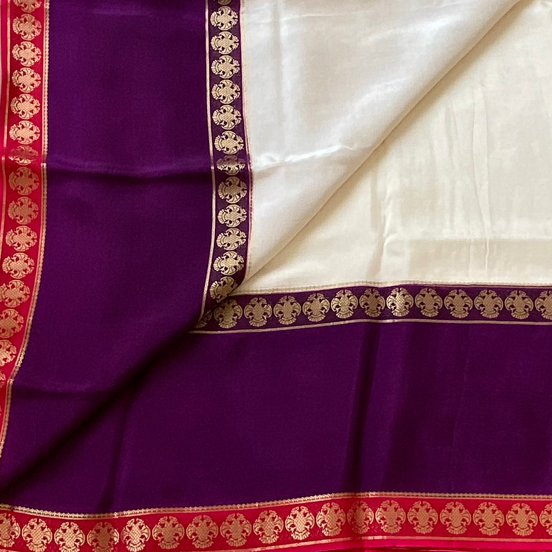 Magical Ivory with purple n pink soft crepe silk with gandaberunda borders