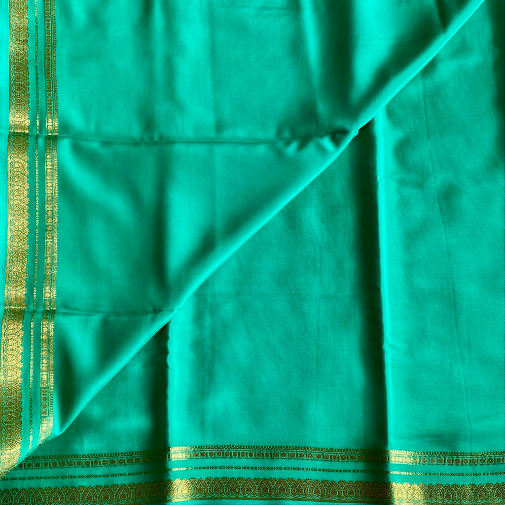 Magical Sea Green Mysore Crepe Silk Saree With Metallic Gold Border