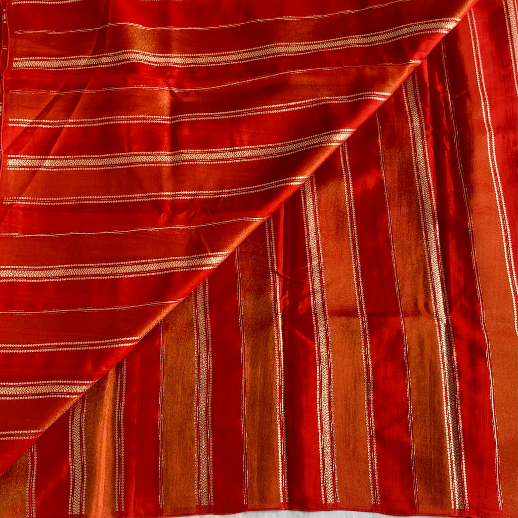 Vermilion Orangish Red Soft Tissue Crepe Saree With Metallic Gold Buttas And Stripes