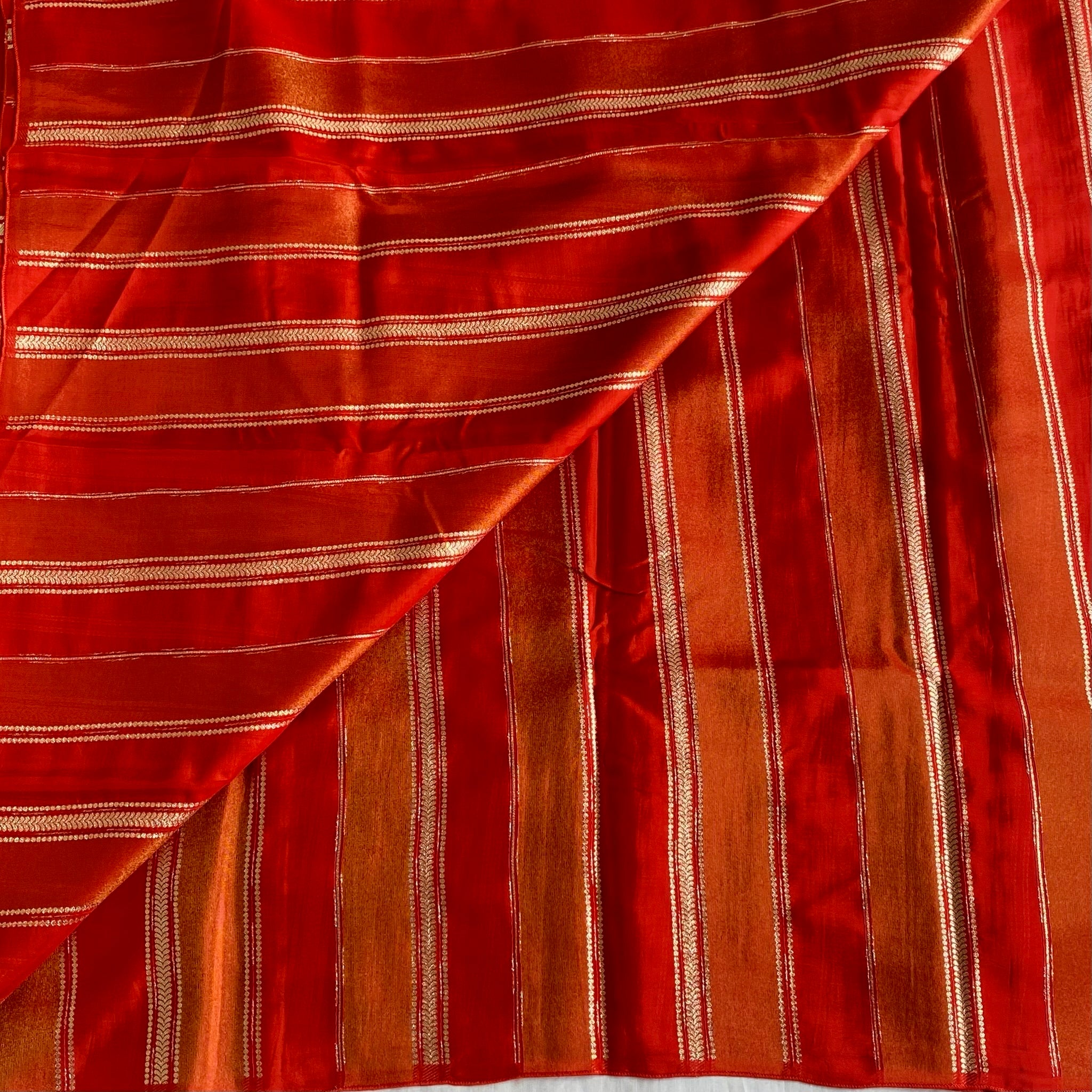 Vermilion Orangish Red Soft Tissue Crepe Saree With Metallic Gold Buttas And Stripes