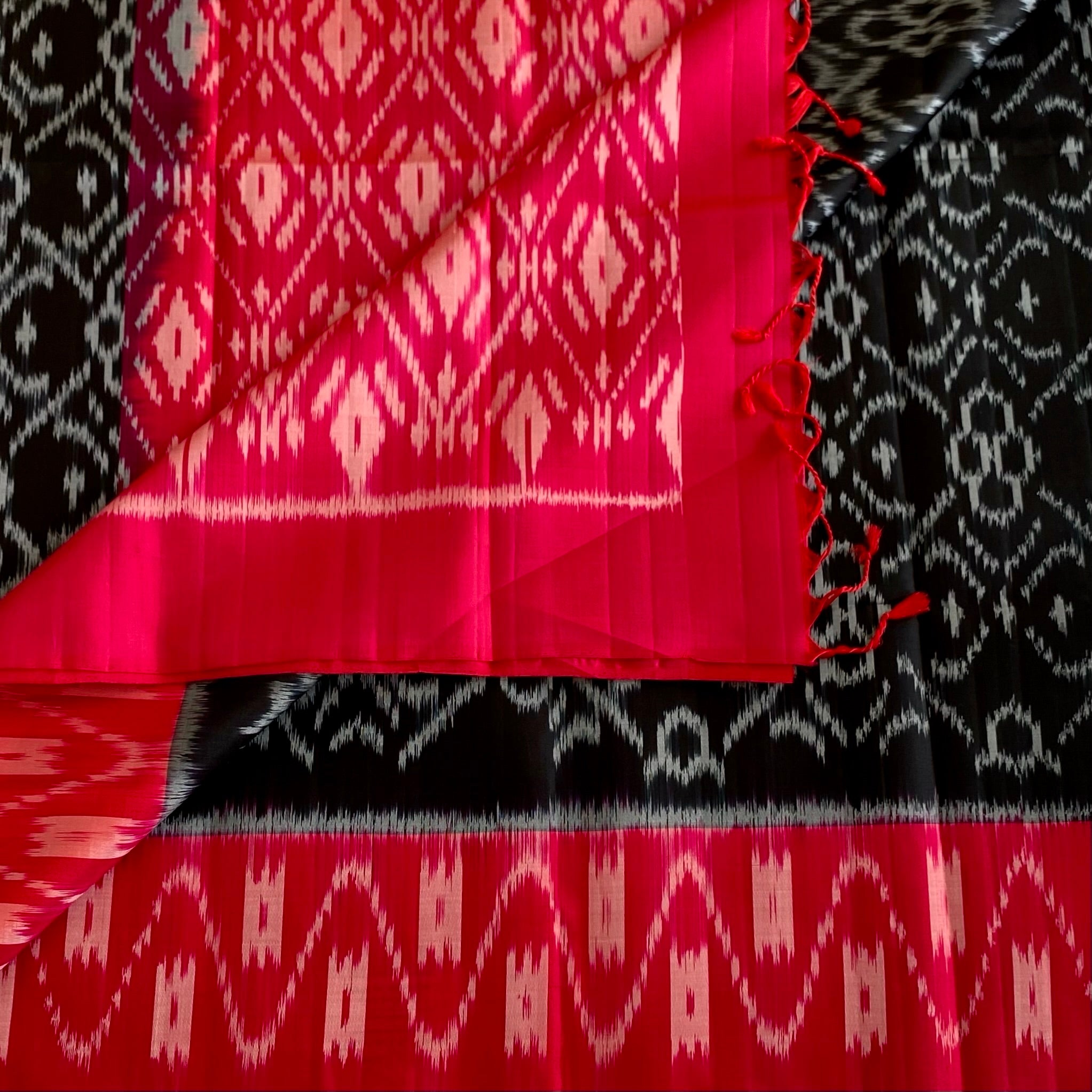 Stunner Jet Black Designer Ikkat Woven Pure silk with Tomato Pink Borders & Pallu