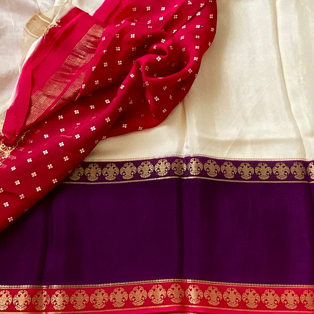 Magical Ivory with purple n pink soft crepe silk with gandaberunda borders