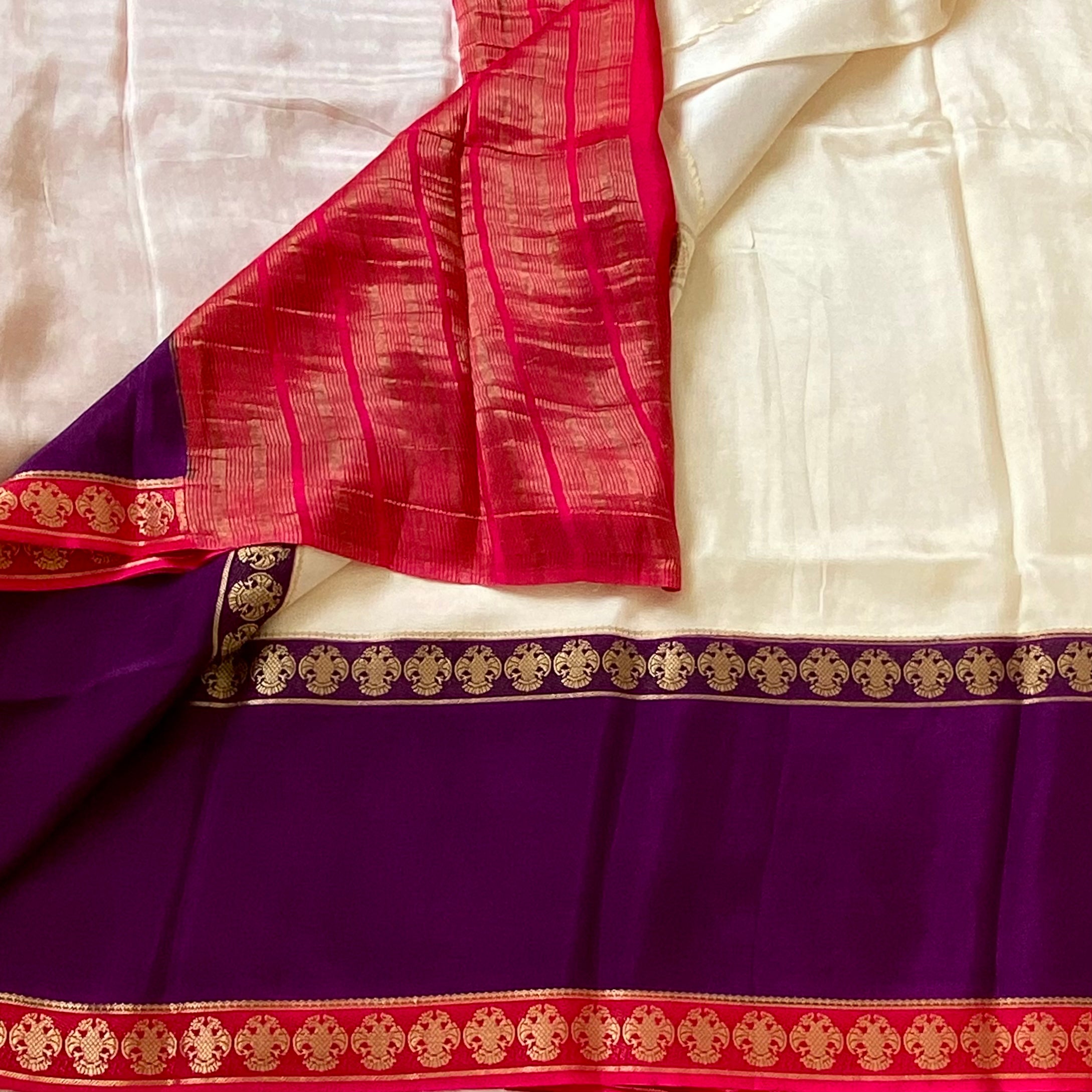 Magical Ivory with purple n pink soft crepe silk with gandaberunda borders