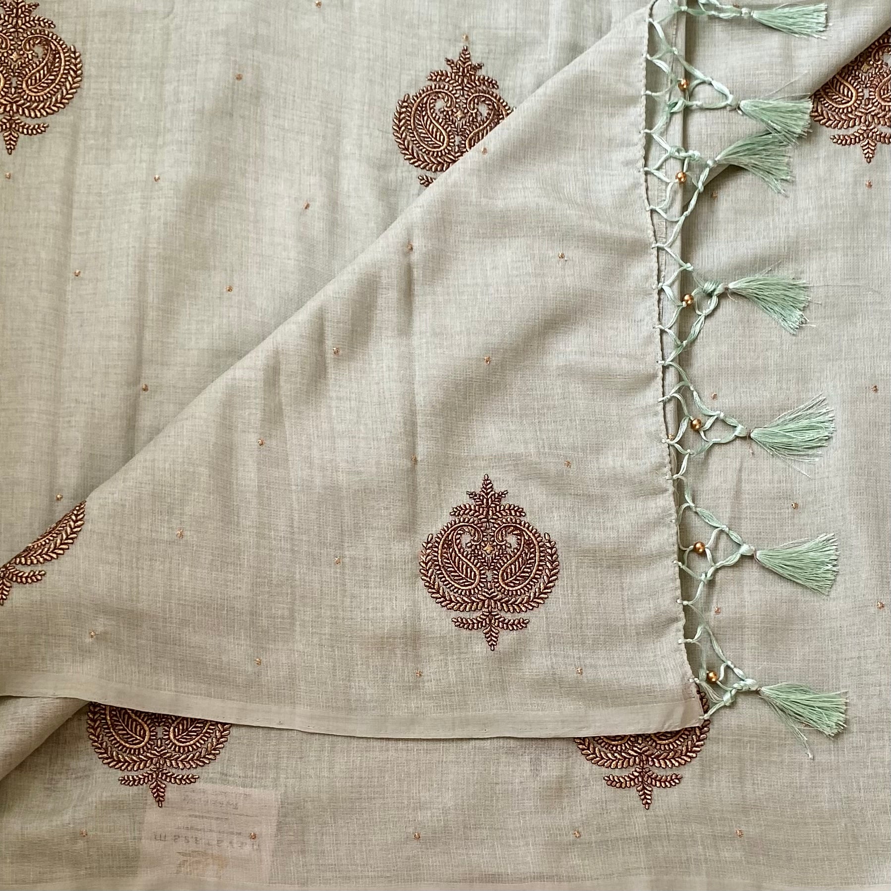 Sage Green Embroidered Saree with Copper Motifs and Tassels Elegant