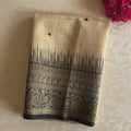 Beige Black Brocade Saree With Gold Paisley Pallu And Tassels