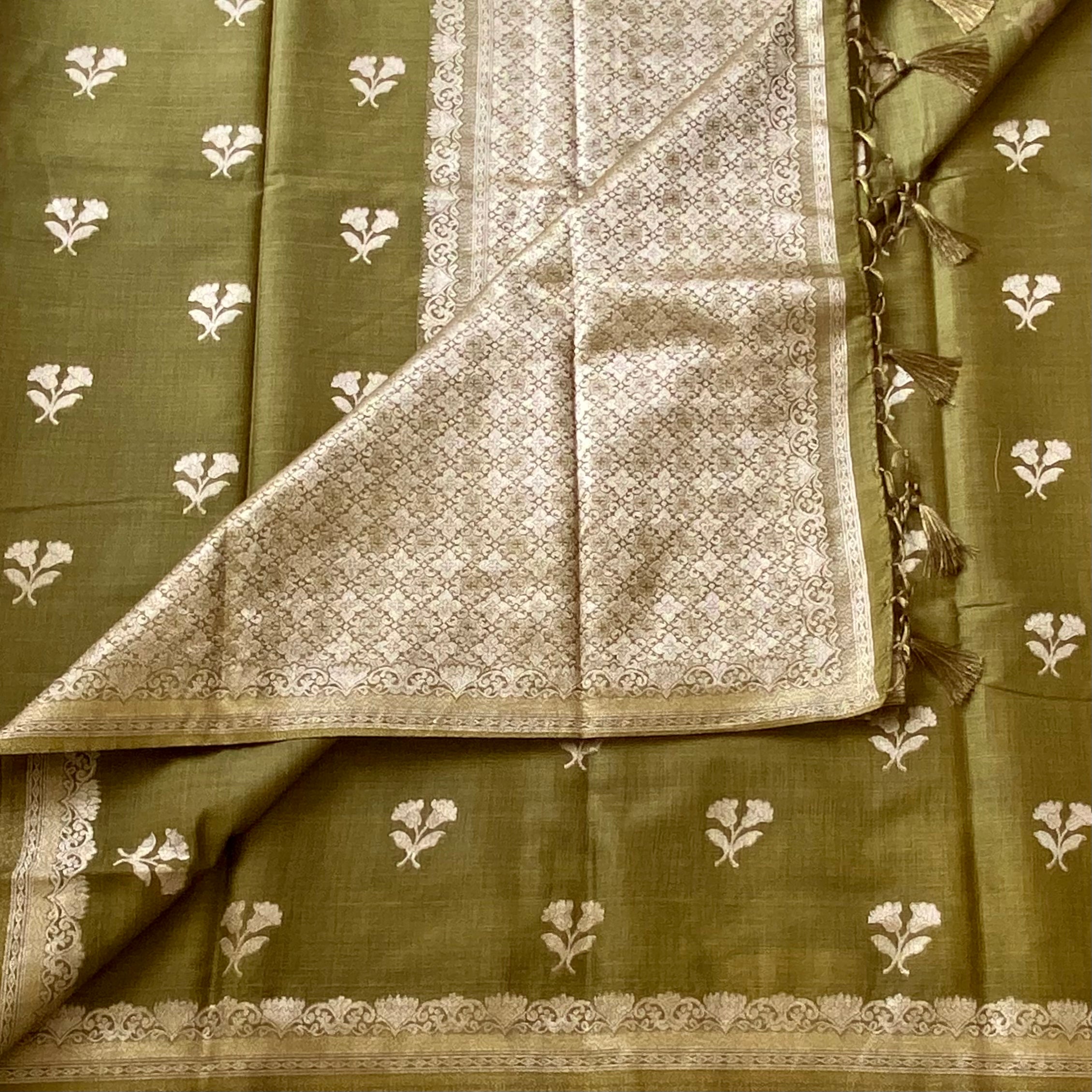 Olive Green soft tussar with antique silver buttas and lotus borders