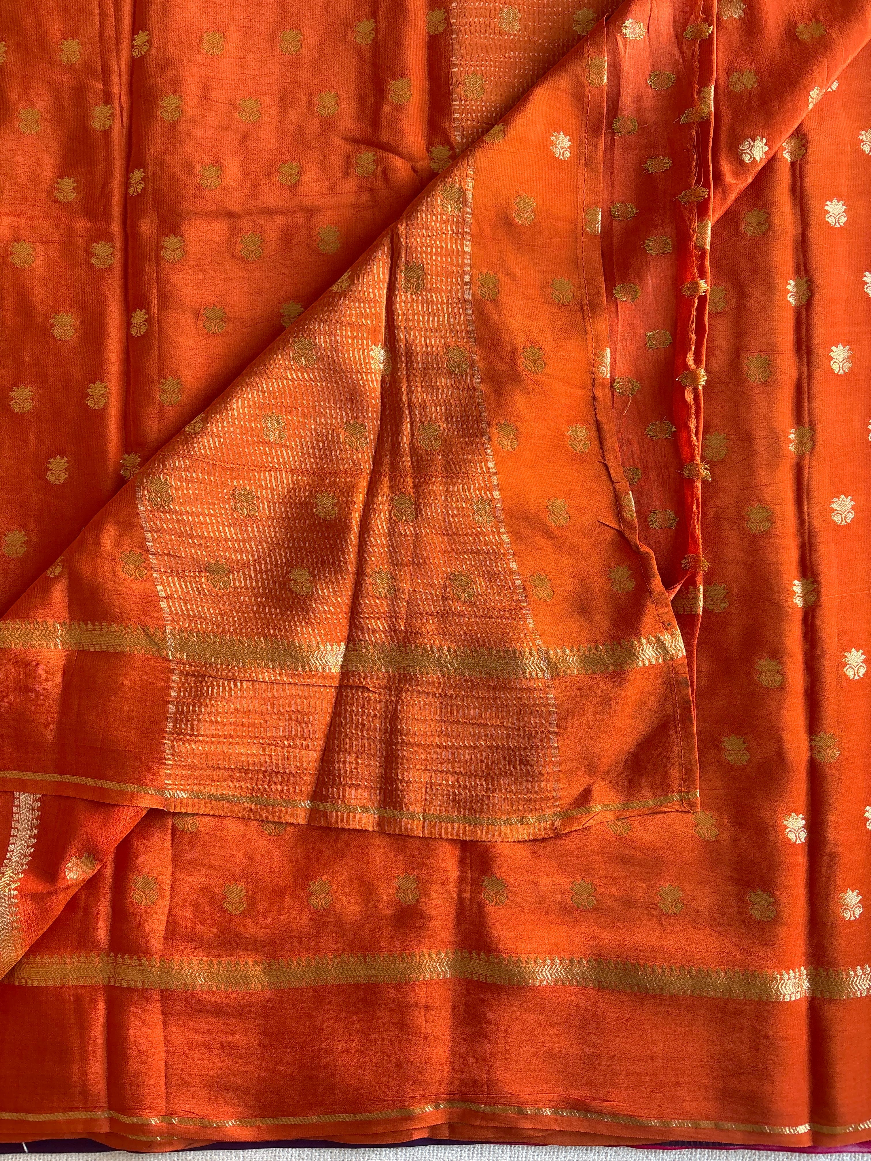 Burnt Orange soft crepe silk with zari woven buttas all over